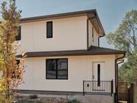 A second front entrance leads to a proper mud room + laundry room with utility sink.