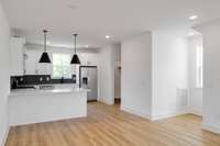 The kitchen is outfitted with sleek stainless steel appliances, and a stylish vent hood, --perfect for the home chef who loves both form and function.