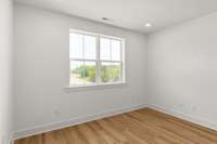 Another view of the primary bedroom, where luxury meets comfort. This generous space offers a serene retreat, complete with large windows that flood the room with natural light and provide stunning views.