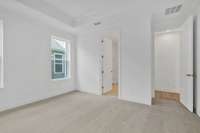 Your primary suite features a tray ceiling and your own private bathroom.