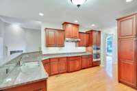 The counter tops are granite and the cabinets are custom made. Recent updates include the back splash and a new refrigerator.
