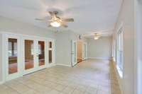 Back inside to the sunroom. The closed doors lead back to the living room and the open French doors lead back to the kitchen.