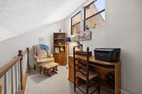 A lofted bonus room makes for a perfect office, overlooking the living room.