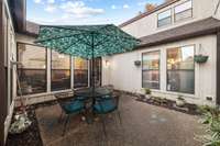 Wrapped by windows from the dining room, the second living room (or den), and the primary suite, the second outdoor patio is a perfect place for entertaining.