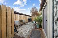 One of two patios is wrapped with new fencing, and features an outdoor storage room.