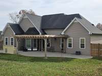 Back of house has pergola for shade over the patio.