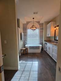 Spacious master bath with double vanity and free standing tub