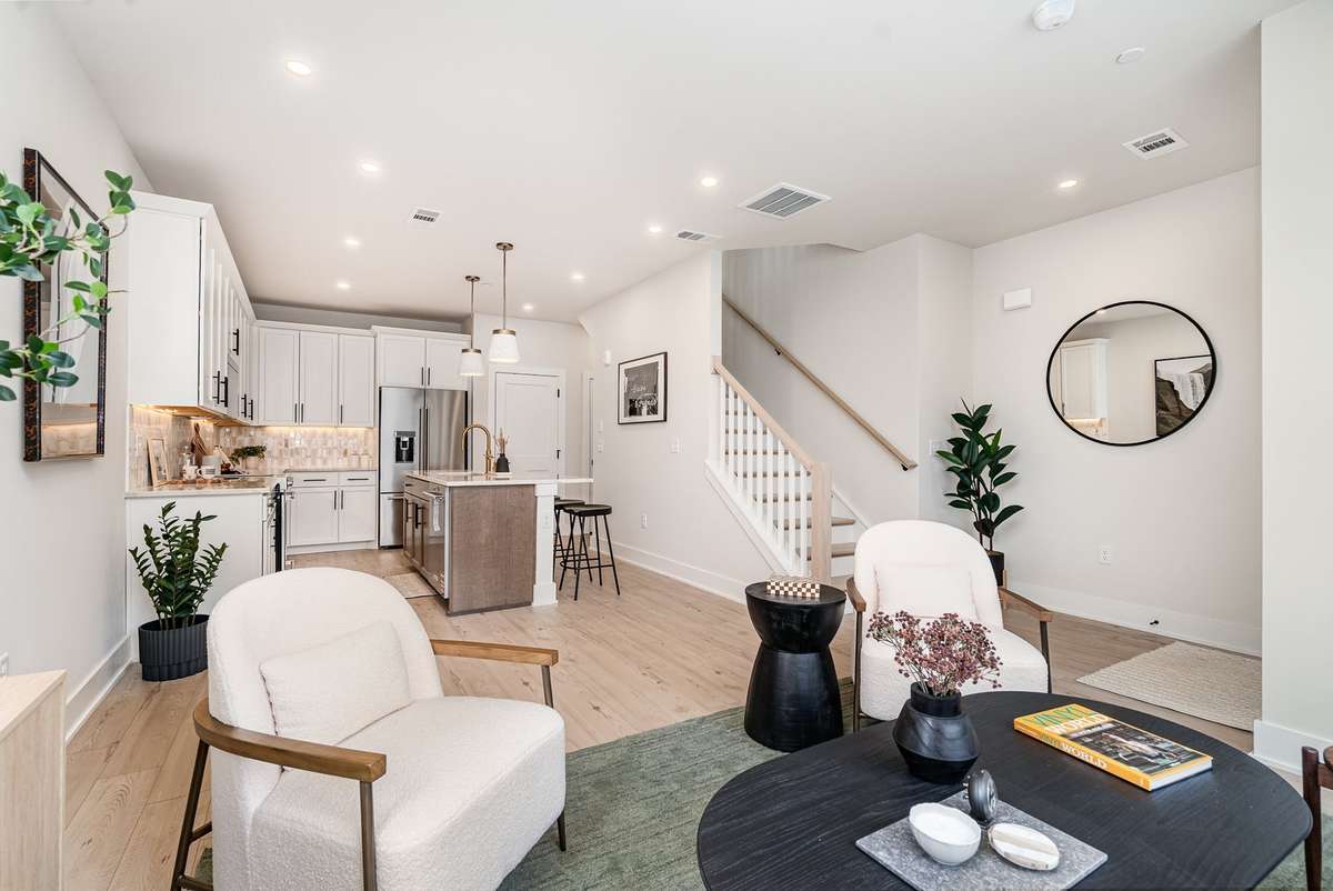 Bright living space flows effortlessly into kitchen *Photos and renderings are for representational purposes only are of a similar floor plan with differing finishes*