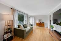sunlit living room- original hardwood floors, new front windows