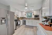 open and bright kitchen with views of the backyard
