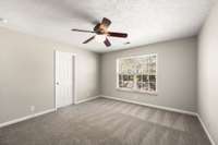 Primary suite overlooks backyard.