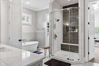 freshly renovated shower with heated floors in the shower and throughout the bathroom; and a soaking tub