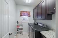 Laundry room with storage cabinets and folding counter.