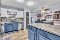 Kitchen with stainless appliances, granite countertops, pantry, bar and coffee bar!