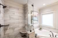 Tile and stone floor in primary shower.