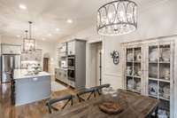 Kitchen nook looking to kitchen and primary suite door.