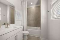 Tile surround in the upstairs secondary bedroom's en suite bath.