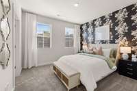 The other secondary bedroom upstairs features bold wallpaper and a walk in closet and en suite bathroom.