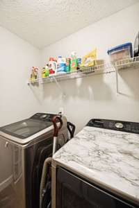 Utility room with neutral color scheme & shelving. 4863 Beryl Dr. Murfreesboro, TN 37128