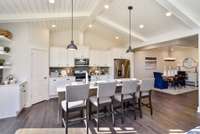 Staggered height cabinets, vaulted ceilings and granite counter tops are included in kitchen. Can it get any better?! Photo not of actual home.