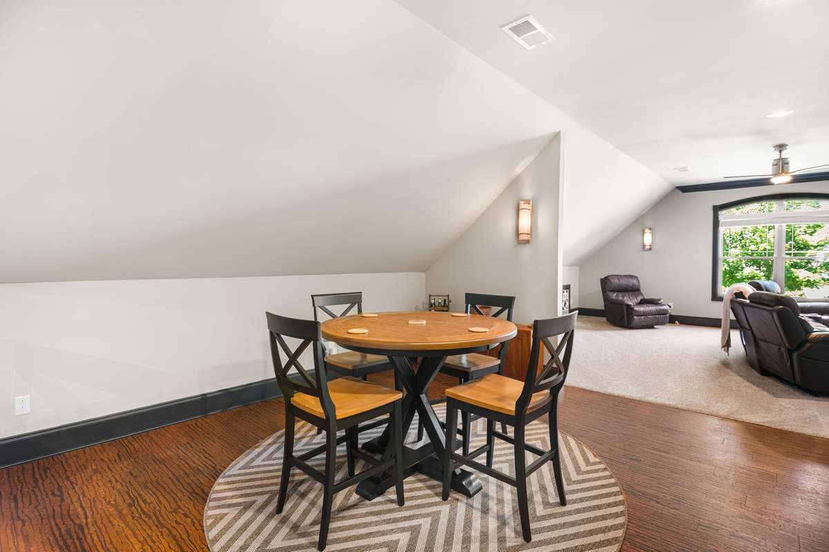 The massive media room offers versatile entertainment. Its extended wet bar and distinctive cork flooring create the perfect setting for both movie nights and lively board or card game gatherings.