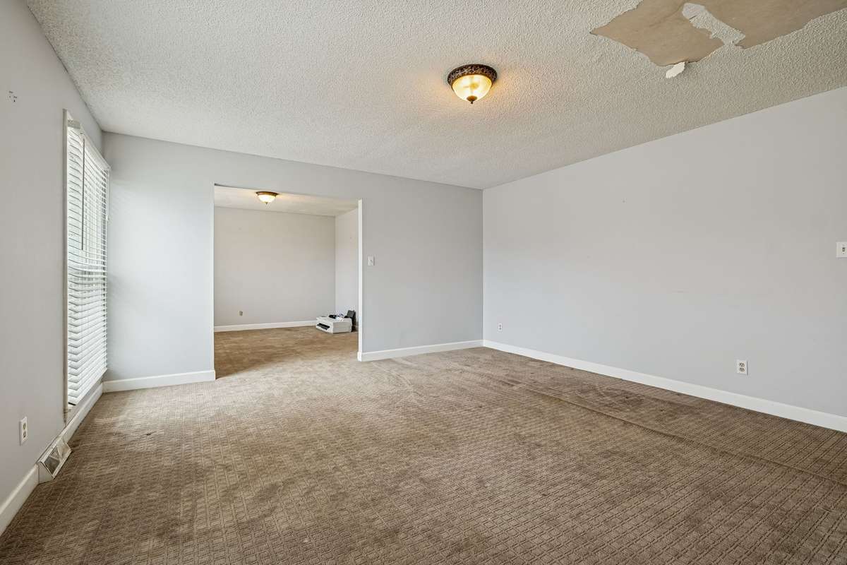 Main living room looking towards the formal dining room and kitchen.