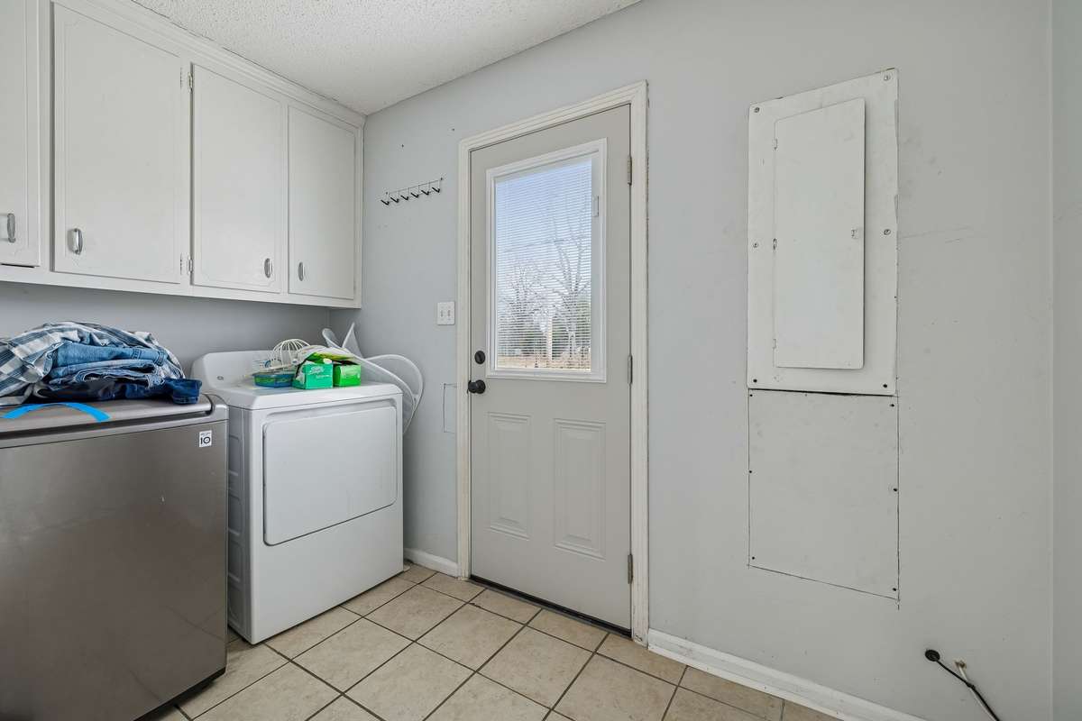 Laundry room and mud room with entrance from the back yard.