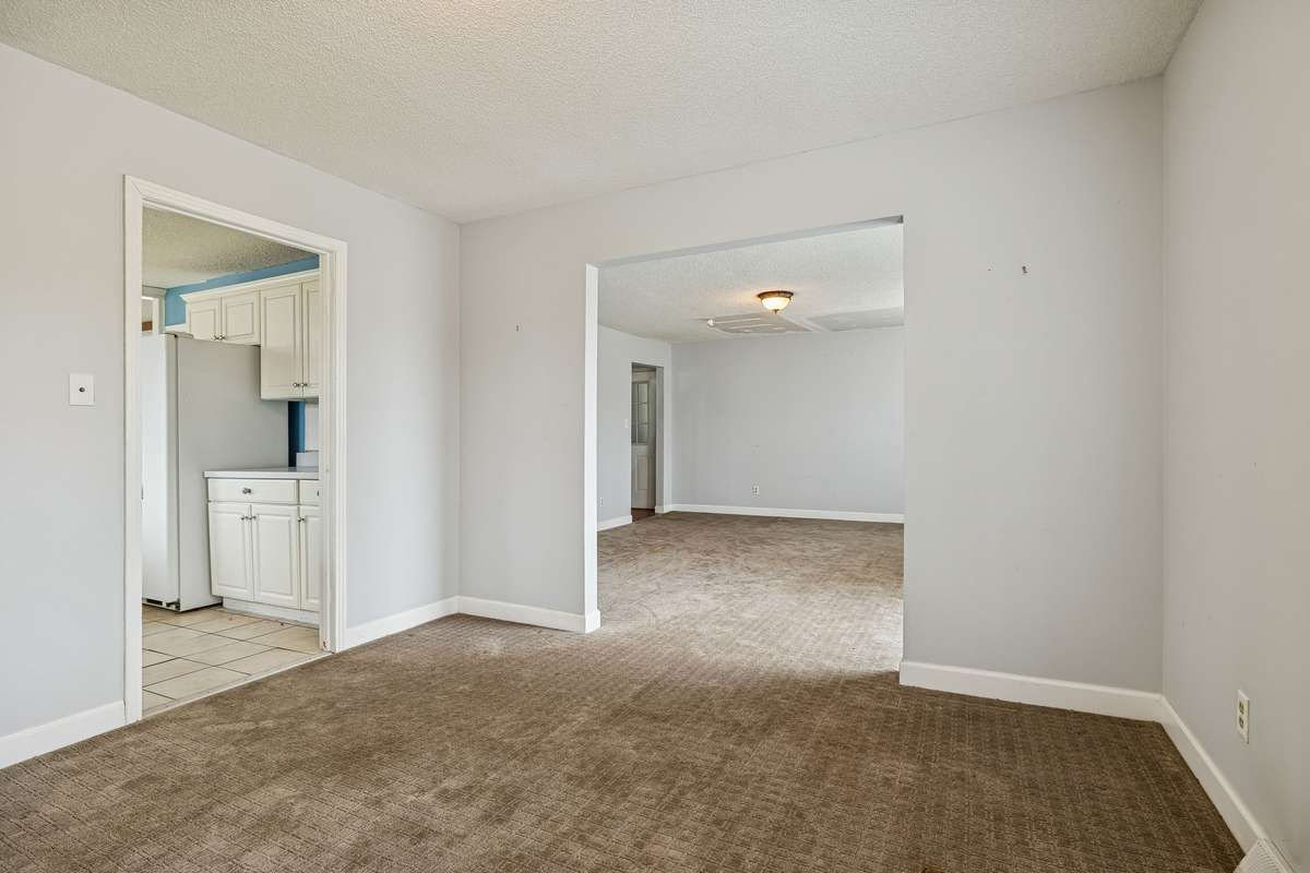 Formal dining room which opens to the main living room and kitchen to the left.