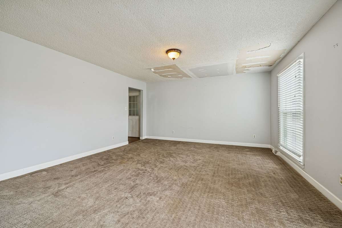 Large main living room. Roof has been repaired.