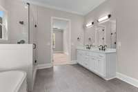 Enjoy double vanities, a walk-in shower, a soaking tub, and a large walk-in closet with upgraded built-in shelving!