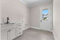 Attached 2-car garage and utility room with rear entrance/exit.