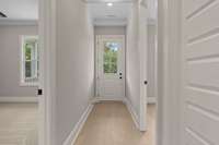 Step into this inviting home through a stylish front door and be greeted by a bright, modern hallway with hardwood floors and recessed lighting.