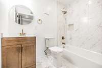 The full hall bath is pristine.