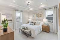 Spacious primary suite upstairs with tray ceiling & private bathroom. King size furnishings pictured here.