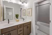 Double vanities for your guests with ceramic tile flooring and separate area for shower.