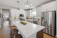 Gourmet chef's kitchen with quartz countertops, ceramic tile backsplash, and SS appliances. Choose between two kitchen layouts at NO cost!