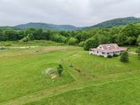Farm house style home, over 15 acres of land, spring fed stocked pond and great views of Short Mountain in Cannon County, TN