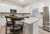 Open Kitchen / Dining / Famly Room - granite counters, light backsplash, white cabinets, huge pantry, island - fridge included!