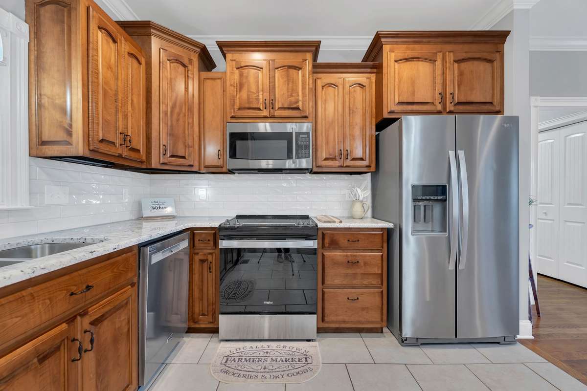 The kitchen features new granite countertops, new backsplash, new stainless appliances, new double sink, new faucet, new garbage disposal and new lighting.