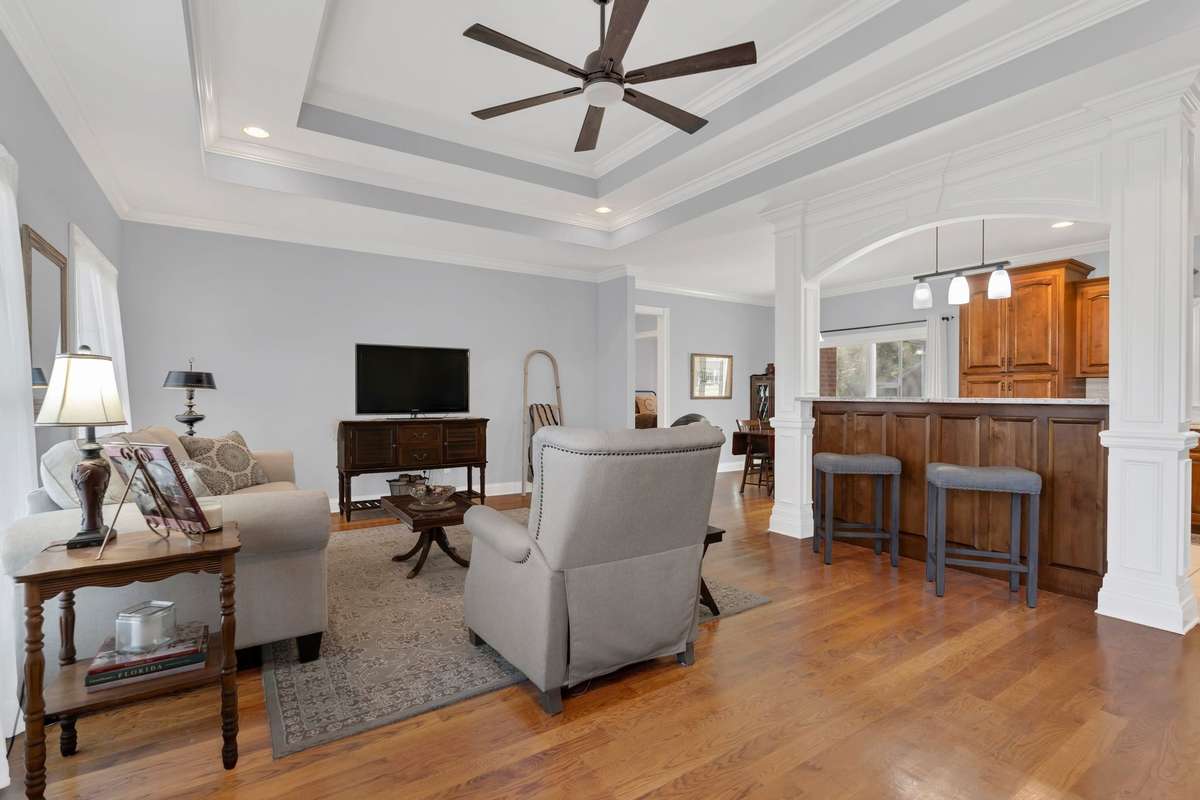 The Great Room features a double tray ceiling with recessed lighting, new ceiling fan and new neutral paint throughout the house.