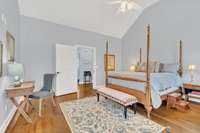 The Primary Suite has vaulted ceilings, hardwood floors, private bath and walk-in closet.