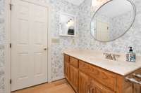 Main floor- 3/4 bath - single vanity, tile shower, linen closet