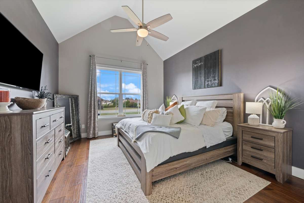 Primary bedroom with vaulted ceilings.