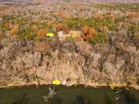 Aerial perspective of this 16-acre retreat—home indicated above and the cleared river access path marked below.