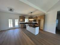 Oversized Dining and Kitchen area combined with custom cabinets and granite countertops included on Island