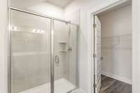 Tile shower in the primary bath *Photos not of exact home*