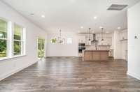 The gourmet kitchen perfectly flows into the large great room + dining area...