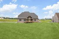 Builder will be adding Sod to the Front and Sides once weather permits, Back yard has already been seeded - This Photo was digitally edited to reflect.