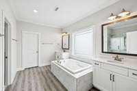 Your spa style bathroom includes dual vanities, a soaking tub, and a walk in tile shower. Thoughtfully designed for both function and luxury.