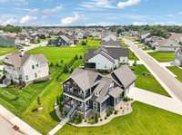 See the full picture: aerials showcase the home’s generous lot, corner placement, and its connection to the neighborhood.